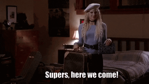 a woman in a blue sweater and white beret is holding a suitcase and says supers here we come