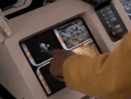 a person is touching a screen with their finger .