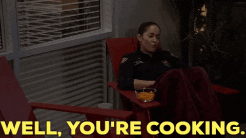 a woman is sitting in a red chair with the words well you 're cooking