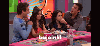 a group of people are sitting at a table with a plate of food and the word bajoink on the bottom