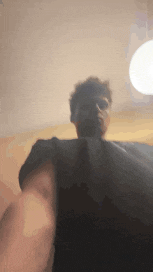 a blurry picture of a person taking a selfie in a room