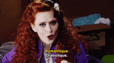 a man in a wig says " romantique diabolique " in a dark room