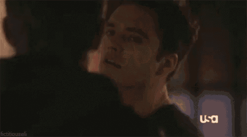 a man and woman are standing next to each other in a dark room .