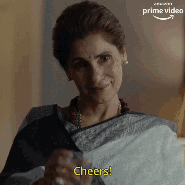 a woman is holding a glass and says cheers on the bottom