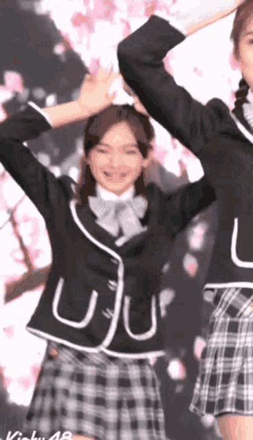 a girl in a school uniform with the letter u on the jacket
