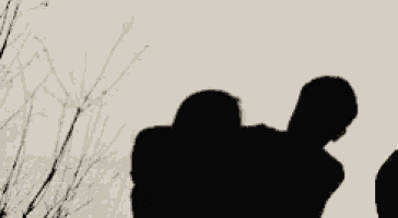 a silhouette of two people standing next to each other with trees in the background