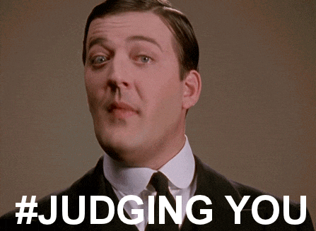 a man in a suit and tie with the words # judging you below him