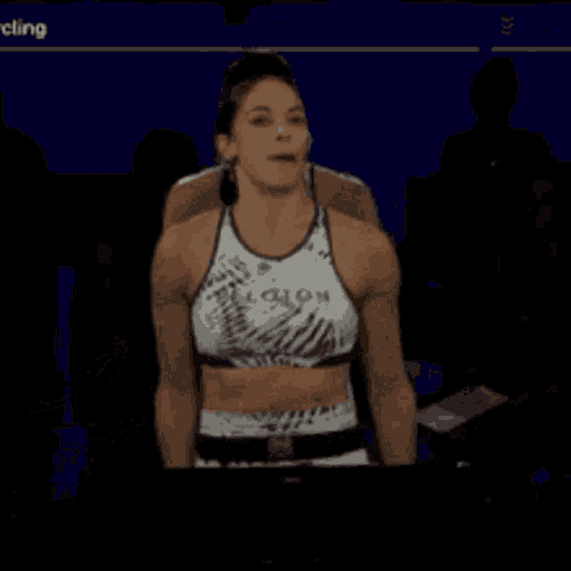 a woman in a crop top that says legion is dancing