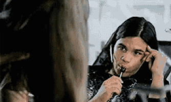 a woman is eating a lollipop while talking on a phone .