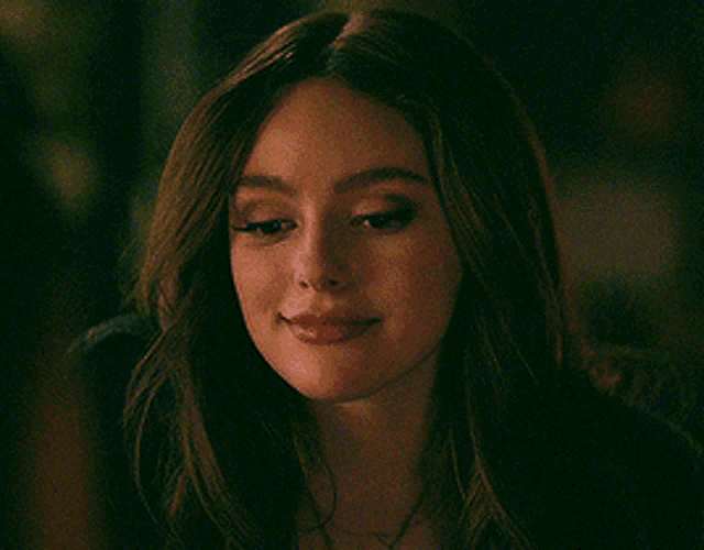 a close up of a woman 's face smiling .