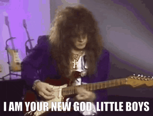 a man with long hair is playing a guitar and says i am your new god little boys .