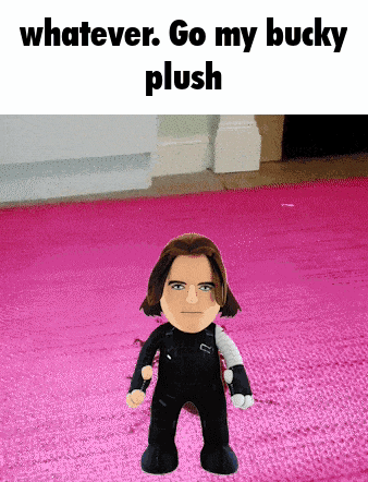 a stuffed bucky standing on a pink rug