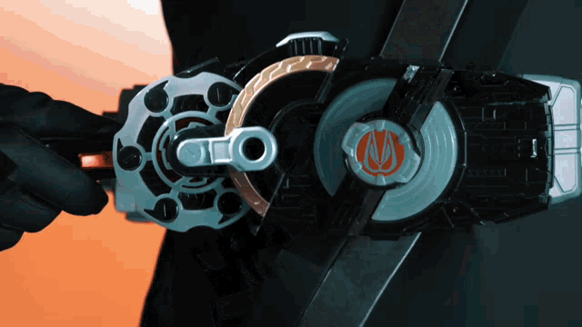 a person is holding a toy that has the letter m on the top