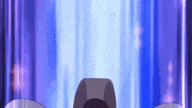 a person is standing in front of a blue curtain with a purple light coming out of it .