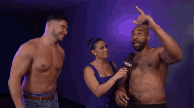 a man without a shirt is being interviewed by a woman with a microphone that says a & w on it
