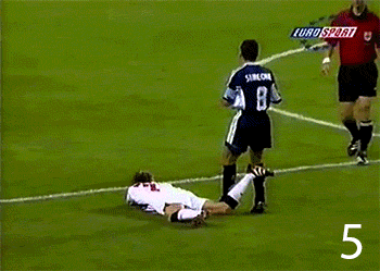 a soccer player with the number 8 on his jersey is laying on the field