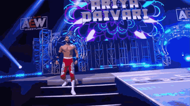 a wrestler is walking down the stairs in front of a sign that says arya davarl