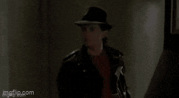 a man is standing in front of a door with the words a chick written on it .