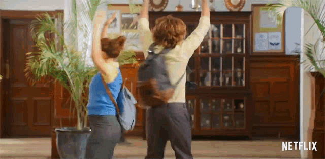 two people are dancing in a room with netflix written on the bottom of the screen .