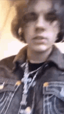 a close up of a person wearing a jacket and sunglasses .