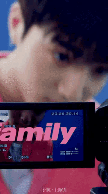 a close up of a person 's face with the word family on the screen