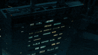 an aerial view of a city at night with lots of lights on