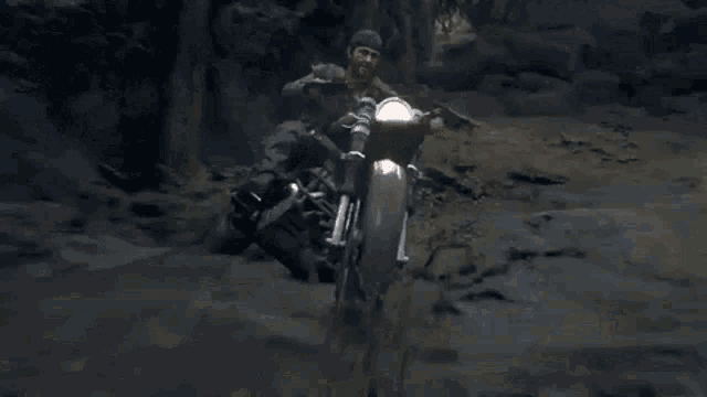 a man is riding a motorcycle on a dirt road .