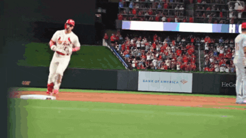 a cardinals baseball player runs to first base