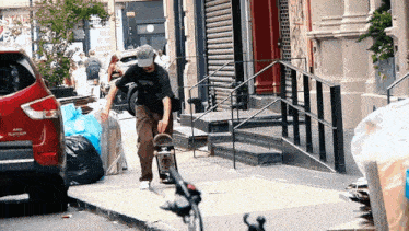 a man riding a skateboard down a sidewalk next to a red suv that says platinum
