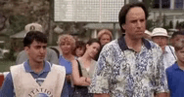 a man wearing a vest that says ' national ' on it is walking with a group of people