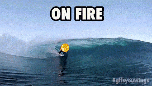 a man is riding a wave in the ocean with the words on fire above him