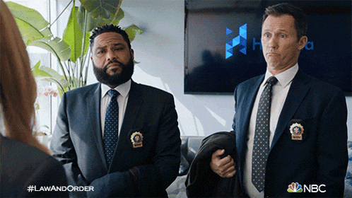 two men in suits and ties standing next to each other with nbc written on the bottom right