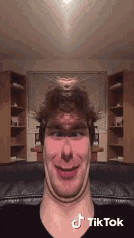 a man is making a funny face with a tiktok watermark on his face