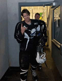 a hockey player wearing a jersey that says lightning is walking through a doorway