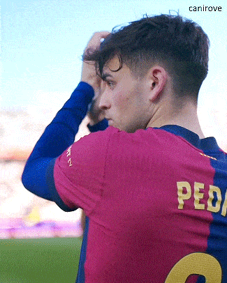 a soccer player with the number 2 on his back adjusts his hair