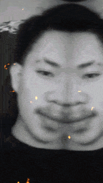 a black and white photo of a man 's face with a blurred background