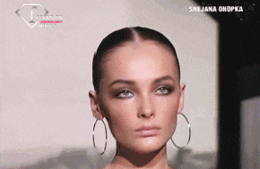 a close up of a woman wearing hoop earrings with the name snjena onopka on the bottom