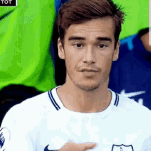 a man wearing a white shirt with a nike logo on it