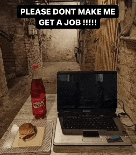 a laptop and a bottle of powerade sit on a table