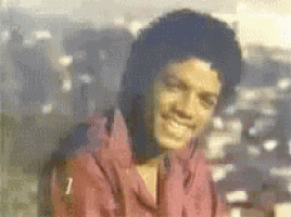 a close up of a person wearing a pink shirt smiling .