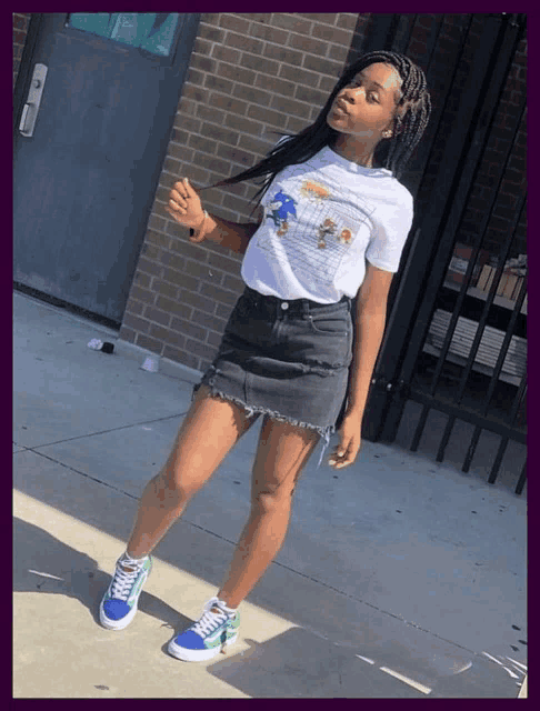 a girl wearing a sonic the hedgehog t-shirt and a black skirt
