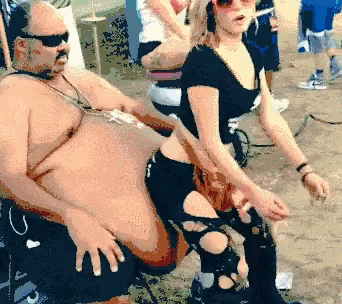 a man and a woman are standing next to each other on the beach