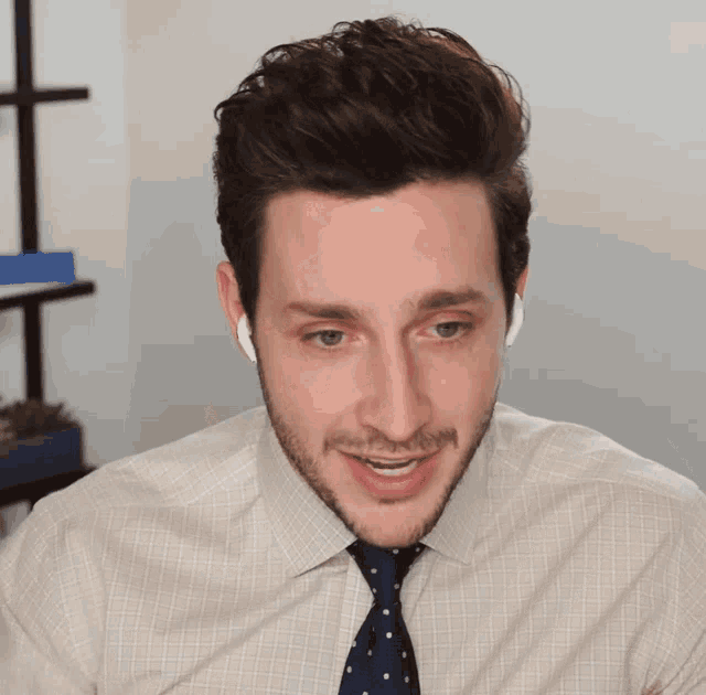 a man with a beard wearing a white shirt and blue tie