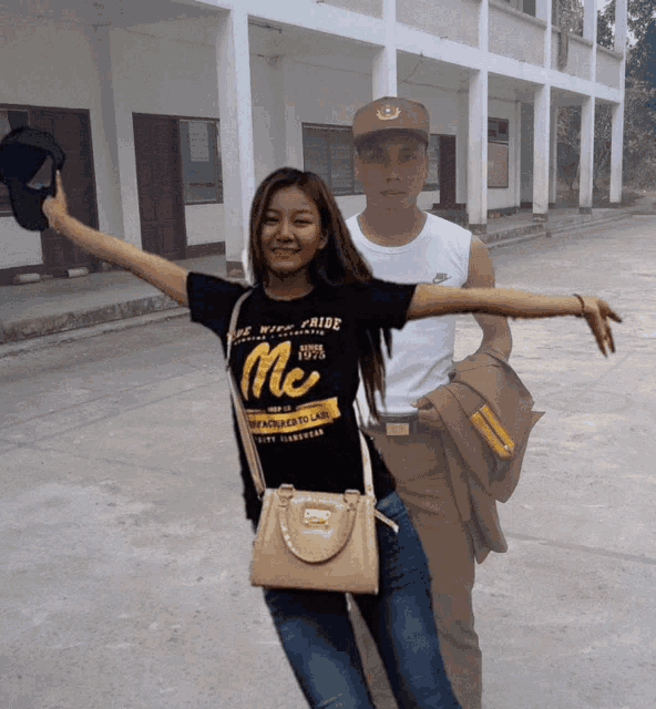 a woman wearing a t-shirt that says me stands next to a man