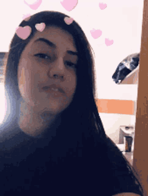 a girl with pink hearts on her face