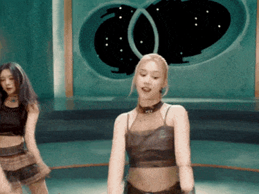 a woman wearing a choker is dancing in front of a green background