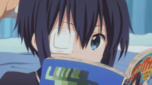 a person with a bandage on their eye is reading a book with the letter l on it
