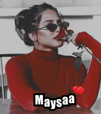 a woman in a red turtleneck is holding a rose and the name maysaa