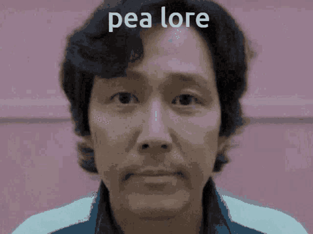 a close up of a man 's face with pea lore written on the bottom
