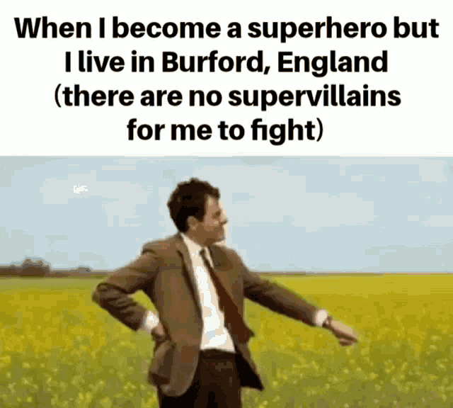 a man in a suit and tie is standing in a field .